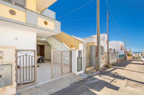 a building with a gate on the side of a street at Casa Anja by BarbarHouse in Marina di Leuca