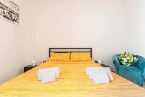 a bedroom with a large bed and a blue couch at Casa Anja by BarbarHouse in Marina di Leuca
