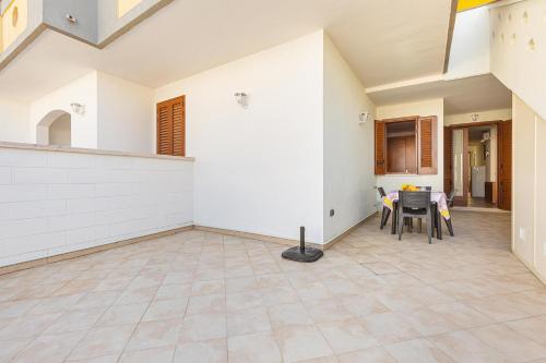 an empty living room with a table and chairs at Casa Anja by BarbarHouse in Marina di Leuca