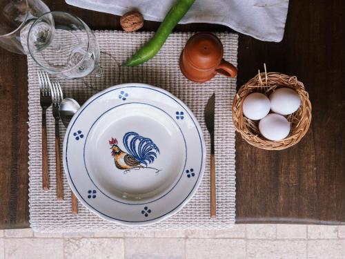 a plate with a chicken on it on a table with eggs at Fattoria del Borgo in Sabina in Rieti