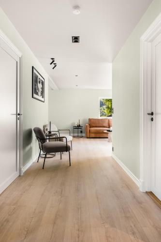 an empty living room with a chair and a couch at Odda Atmosphere in Odda