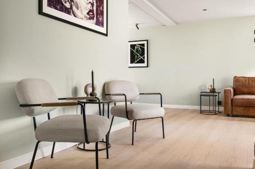 a room with two chairs and a table and a couch at Odda Atmosphere in Odda