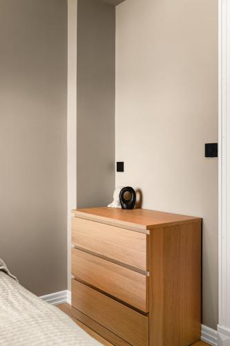 a bedroom with a dresser with a clock on it at Odda Atmosphere in Odda