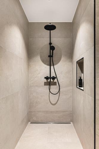 a shower in a bathroom with a wall at Odda Atmosphere in Odda