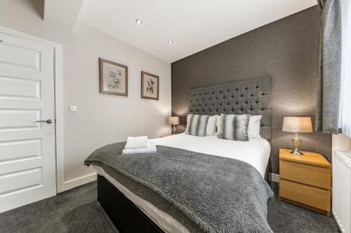 a bedroom with a large bed in a room at Abbey Apartments Modern ApartHotel for Tourists & Professionals in Barrow in Furness