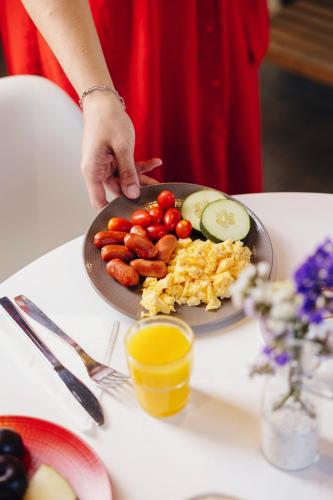 a person holding a plate of food on a table at Ibis Sevilla in Seville