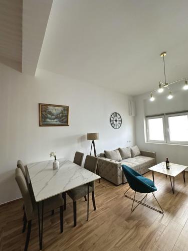a living room with a table and a couch at Apartments Golden View in Kotor