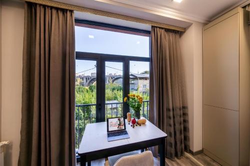 a room with a window with a desk and a laptop at Apartment KeyGo #0010 next to St Sarkis Church in Yerevan