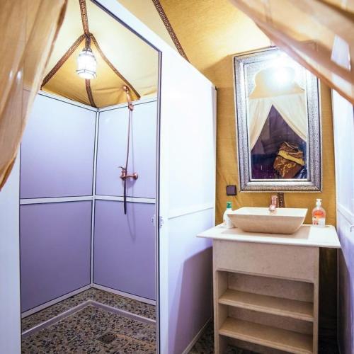 a bathroom with a shower and a sink at Original Luxury Camp in Merzouga