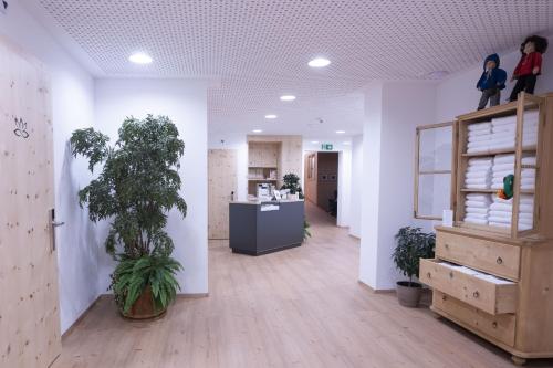 a room with a hallway with plants in it at Chasa Helvetia Trai in Müstair