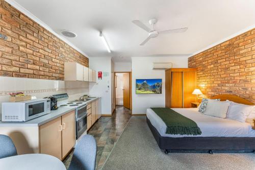 a hotel room with a bed and a kitchen at BIG4 Tasman Holiday Parks - Warrnambool in Warrnambool