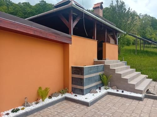 a house with stairs in front of it at Casa Jazmin Covasna in Covasna