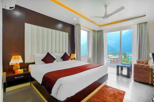 a bedroom with a large bed and a large window at Aliza Inn And Suites By SRS Hotels in Dharamshala