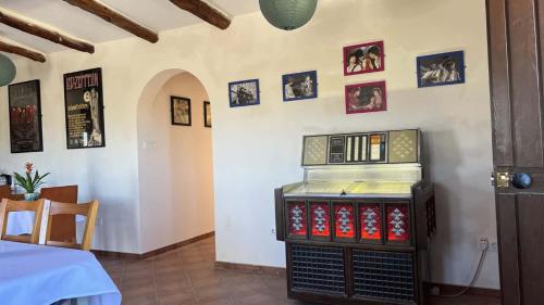 a room with a table with a display of dvds at Cortijo La Cueva in Arboleas