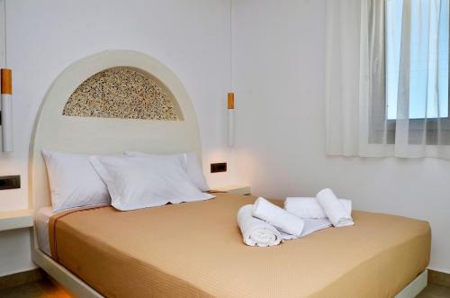 a bedroom with a bed with two towels on it at Lilian Studios in Koufonisia