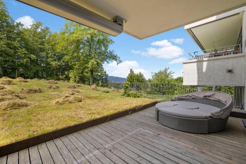 a patio with a bed on a deck at Exclusive spacious Apt. with garden in Zurich in Zürich