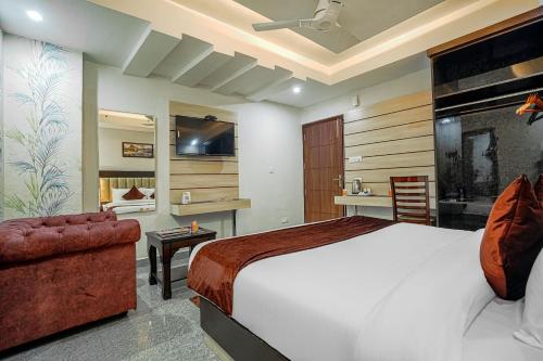 a bedroom with a large bed and a bathroom at Aliza Inn And Suites By SRS Hotels in Dharamshala