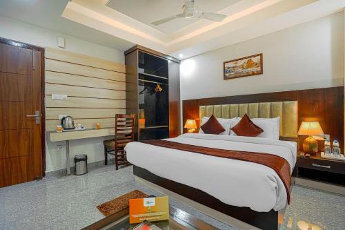 a hotel room with a large bed and a desk at Aliza Inn And Suites By SRS Hotels in Dharamshala