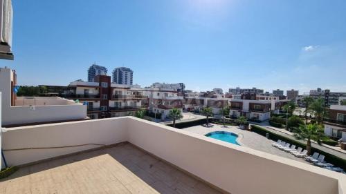 a view from the balcony of a apartment with a swimming pool at Sunny Pearl of Cyprus in İskele