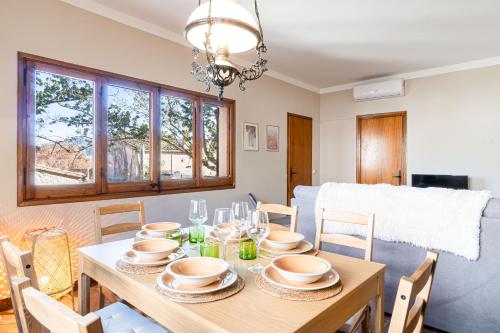 a dining room with a wooden table and chairs at Cozy house in Priorat! Barbecue & Relax - Climbing & Views in Poboleda