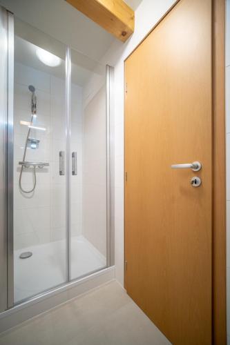 a bathroom with a shower and a glass door at Apartment Riviera 504-4 Lipno Home in Český Krumlov