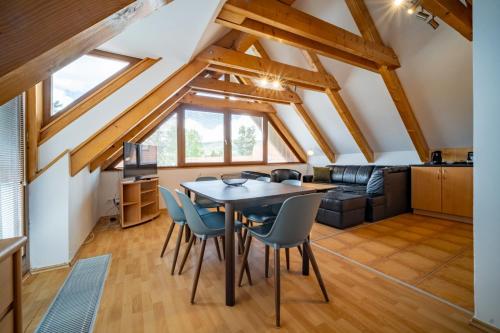 a kitchen and living room with a table and chairs at Apartment Riviera 504-4 Lipno Home in Český Krumlov