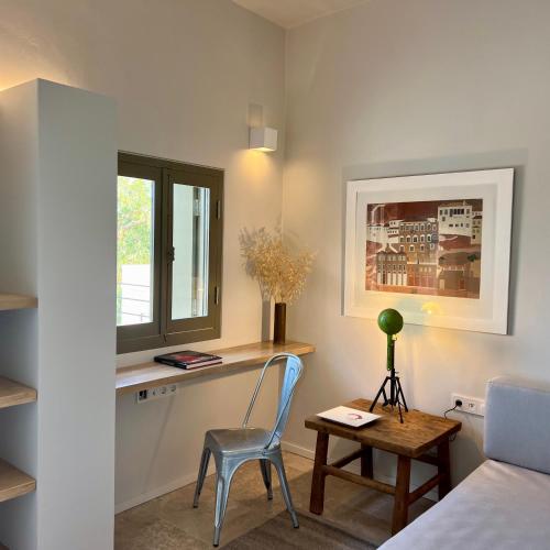 a bedroom with a desk and a chair and a bed at Nikolaou Art Residence in Aegina Town
