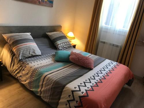 1 cama con almohadas en el dormitorio en Appartement cocooning plage des lecques en Saint-Cyr-sur-Mer