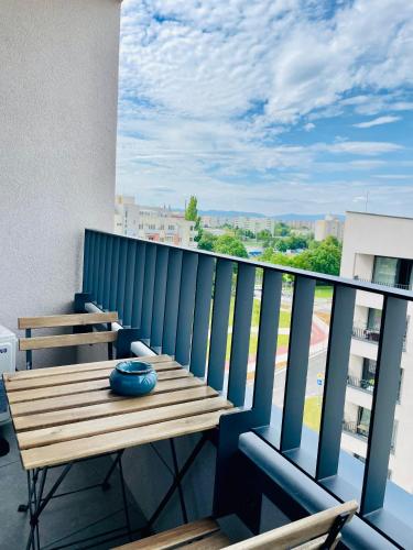 a balcony with a wooden table and a blue vase at SmartApartment Prúdy Trnava, Free Parking, 800m CityArena in Trnava
