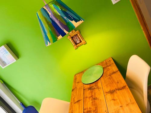 a green dining room table with a green wall at The Beachhouse Apartments in Vaia