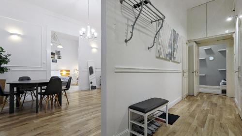 a dining room and living room with a table and chairs at 3 room apartment in the beautiful street in Budapest