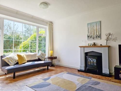 a living room with a couch and a fireplace at Valetta Park in Emsworth