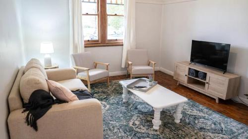 a living room with a dog laying on a couch at East Albury home near hospital & sports precinct in Albury