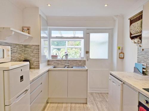 a kitchen with a sink and a window at Valetta Park in Emsworth