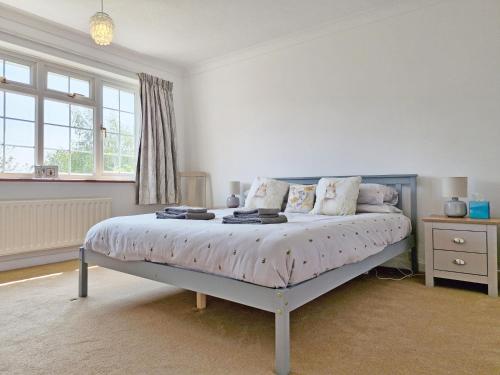 a bedroom with a bed with a blue frame at Valetta Park in Emsworth