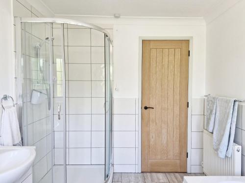 a bathroom with a shower and a glass door at Valetta Park in Emsworth