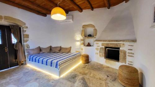a bedroom with a bed and a fireplace at Villa ABBA in Plaka