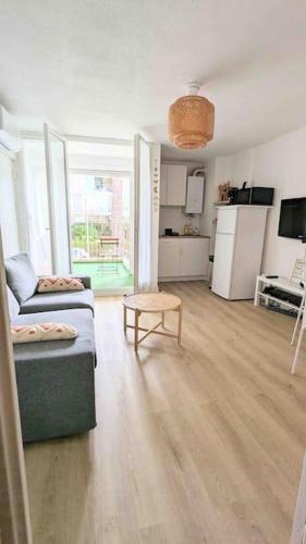 un salon avec un canapé et une table dans l'établissement Studio climatisé 4 pers, balcon, parking, à La Grande Motte