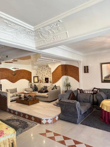 a large living room with couches and a table at Luxury duplex in the centre of Maarif in Casablanca