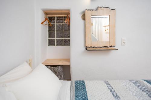 a bedroom with a bed and a mirror on the wall at Feel the Serenity 2 in Galini