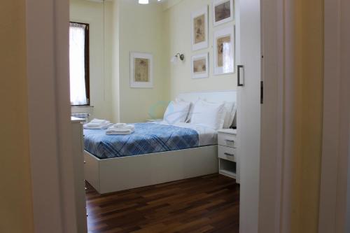 a bedroom with a bed with a blue comforter at Your Perfect Roman Getaway in Vatican in Rome