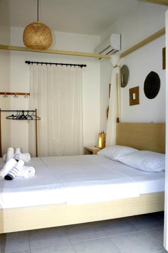a bedroom with a large bed with white sheets at Arco In Pietra in Apolakkiá