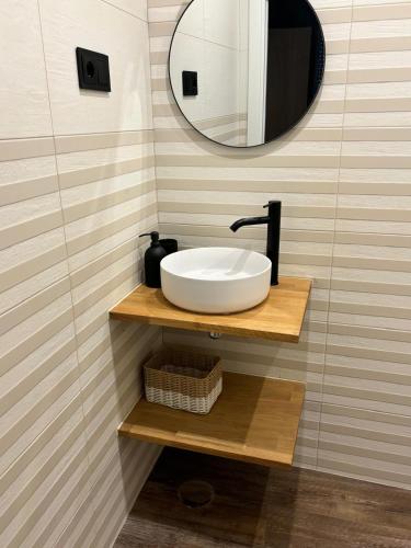 a bathroom with a sink and a mirror at NOARU Apartamentos in Ares