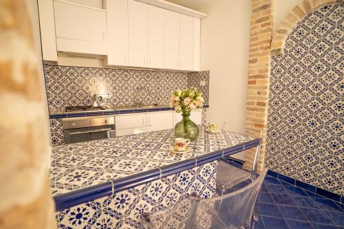 a kitchen with a vase of flowers on a counter at La casetta in Tortoreto Lido