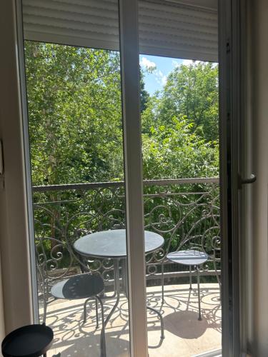 a patio with a table and chairs on a balcony at Stan na dan Zvezdara in Zvezdara