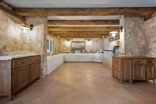 uma grande cozinha com armários de madeira e um lavatório em Boutique Guesthouse Sveti Petar, on the beach, heated pool, restaurant & boat berth - ADULT ONLY em Nečujam