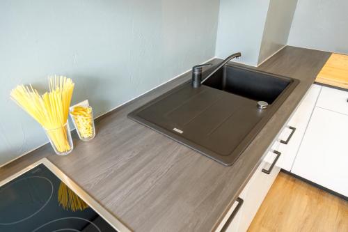 a kitchen with a sink and a counter with pasta at Ferienwohnung Achim in Isny in Isny im Allgäu