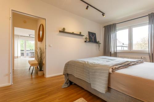 a bedroom with a bed and a large window at Ferienwohnung Achim in Isny in Isny im Allgäu