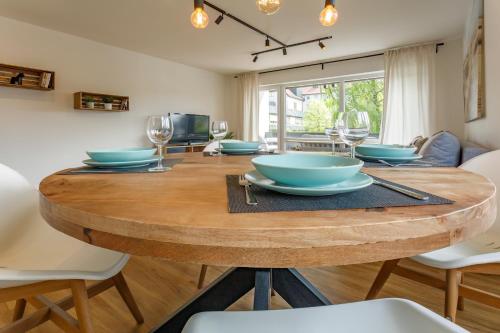 a dining room table with blue bowls and wine glasses at Ferienwohnung Achim in Isny in Isny im Allgäu