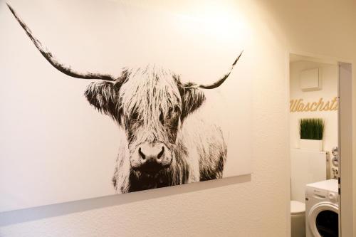 a picture of a cow with horns on a wall at Ferienwohnung Achim in Isny in Isny im Allgäu